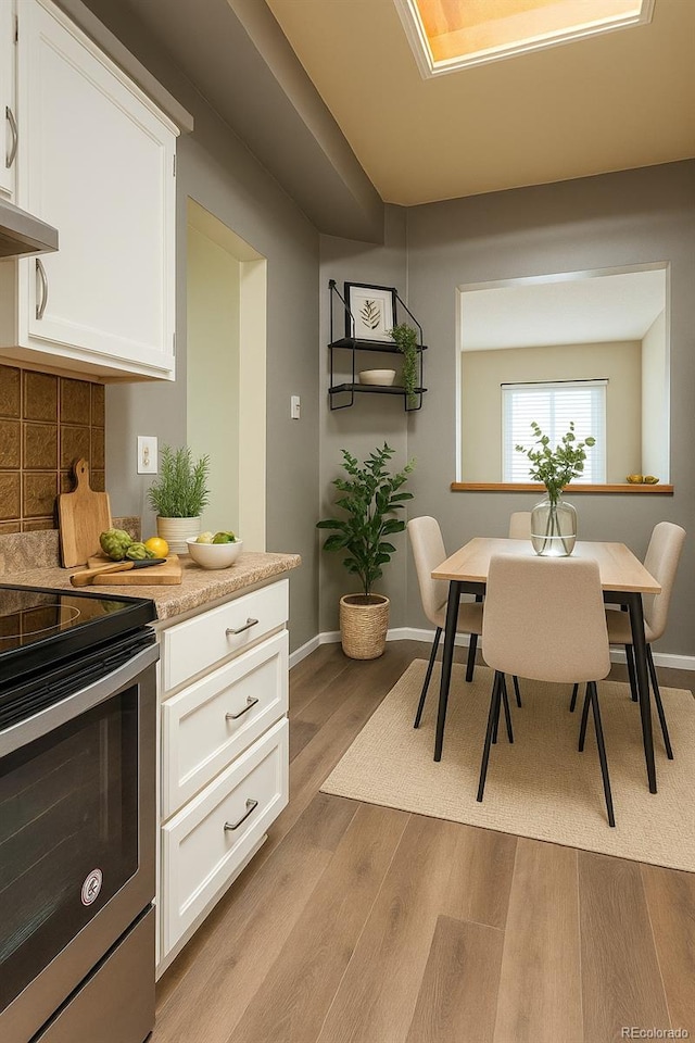5555 E Briarwood Ave Unit 706, Centennial, CO 80122 - dining area with light wood finished floors and baseboards