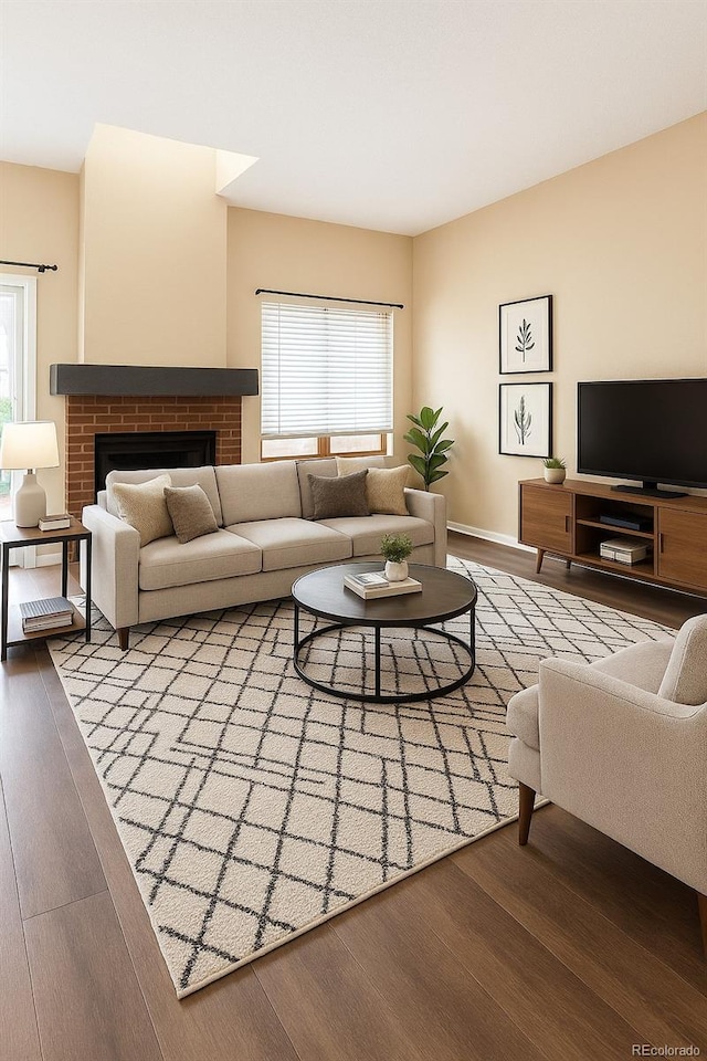 5555 E Briarwood Ave Unit 706, Centennial, CO 80122 - living room featuring wood finished floors, healthy amount of natural light, and a brick fireplace