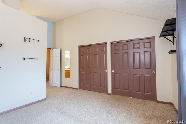 5555 E Briarwood Ave Unit 706, Centennial, CO 80122 - unfurnished bedroom with carpet, two closets, lofted ceiling, and baseboards