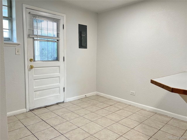 doorway with light tile patterned floors and electric panel