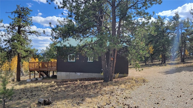 view of home's exterior featuring a wooden deck