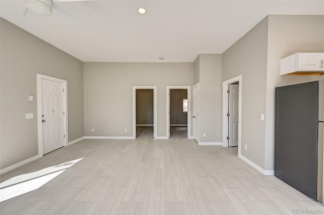 empty room with light hardwood / wood-style flooring