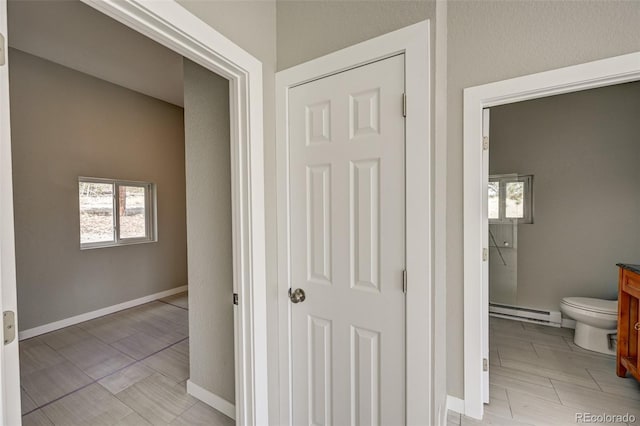 hallway with a baseboard heating unit