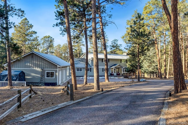 view of front of property featuring board and batten siding and driveway