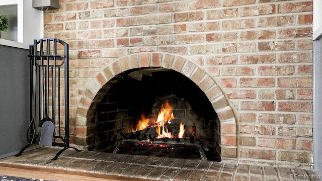 interior details featuring a brick fireplace