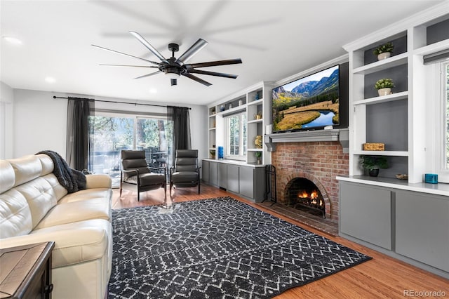 living room featuring ceiling fan, recessed lighting, wood finished floors, and a fireplace