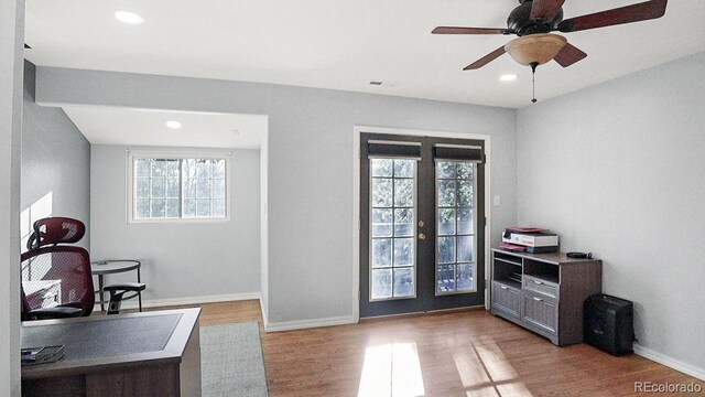 office space featuring plenty of natural light, recessed lighting, baseboards, and wood finished floors