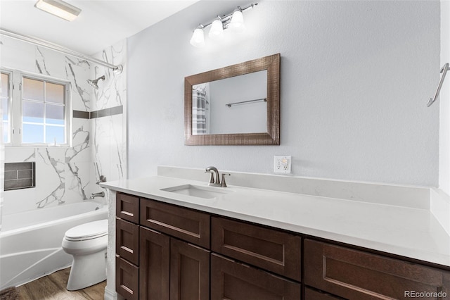 full bathroom featuring shower / washtub combination, toilet, vanity, and wood finished floors