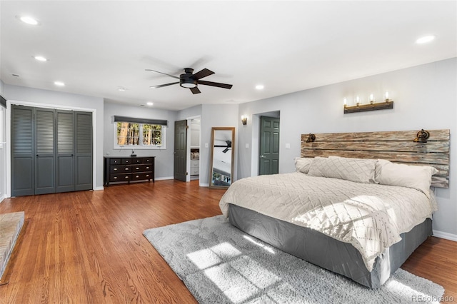 bedroom with a ceiling fan, recessed lighting, wood finished floors, and baseboards