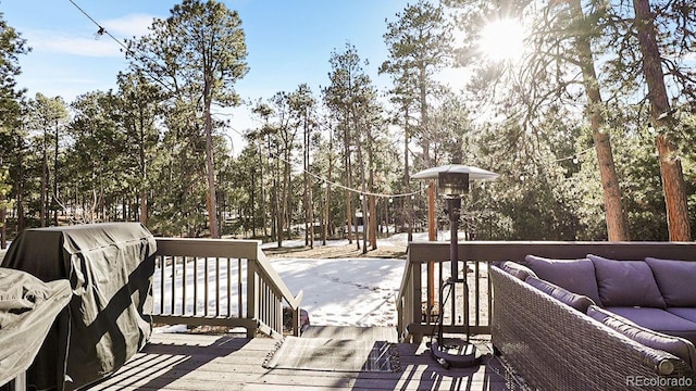 wooden terrace featuring grilling area and an outdoor hangout area