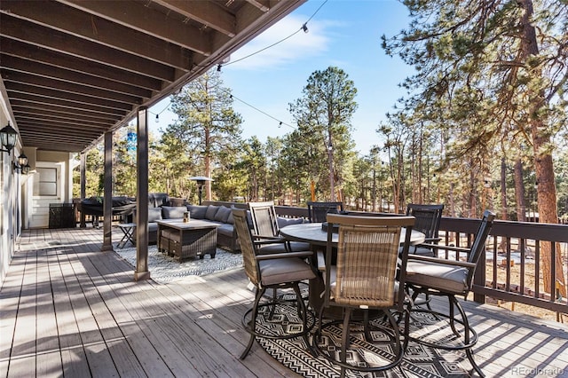 deck featuring outdoor dining space and outdoor lounge area