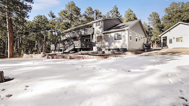 view of snow covered exterior featuring stairway