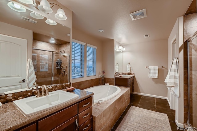 bathroom with a sink, visible vents, and a shower stall