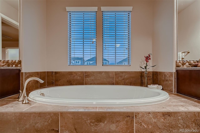 bathroom featuring vanity and a bath