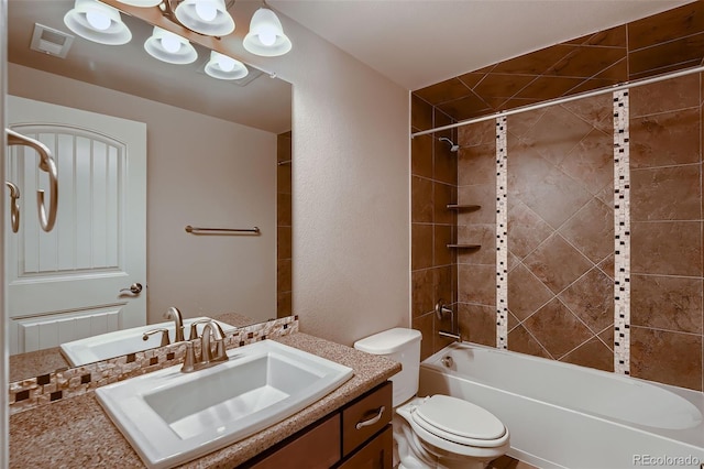 bathroom featuring toilet, vanity, shower / tub combination, and visible vents