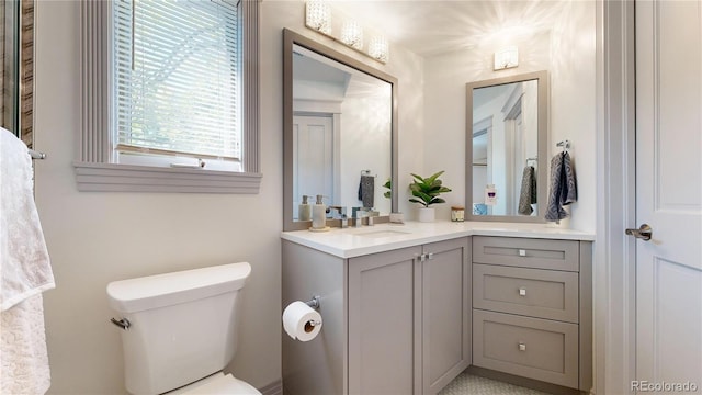 bathroom featuring toilet and vanity