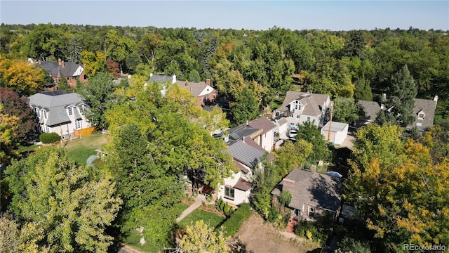 aerial view with a wooded view and a residential view