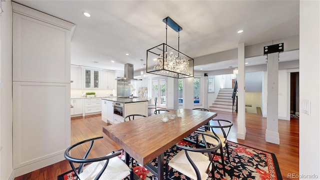 dining area featuring light wood-style flooring, recessed lighting, and stairs
