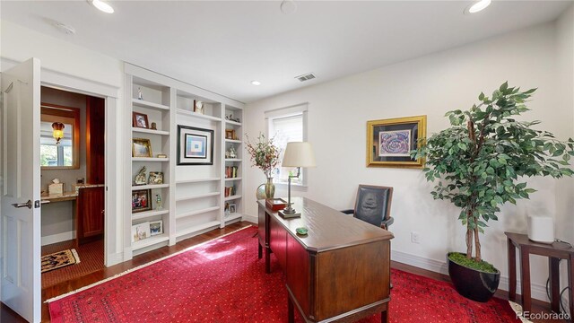 office featuring wood finished floors, baseboards, visible vents, and recessed lighting