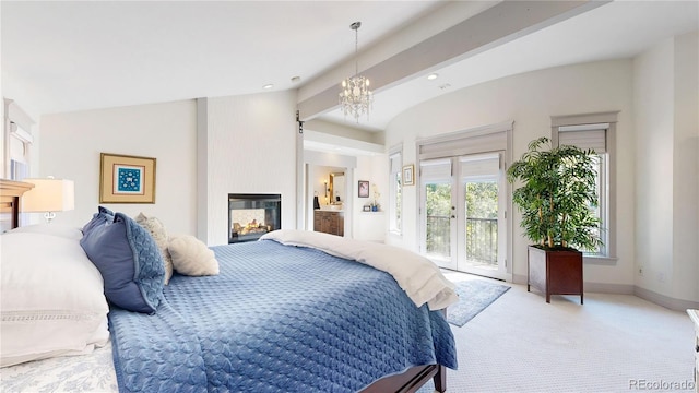bedroom featuring access to outside, an inviting chandelier, light colored carpet, a glass covered fireplace, and recessed lighting