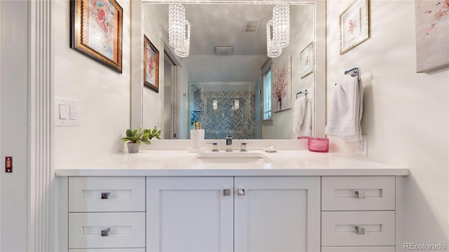 bathroom with vanity, visible vents, and a stall shower