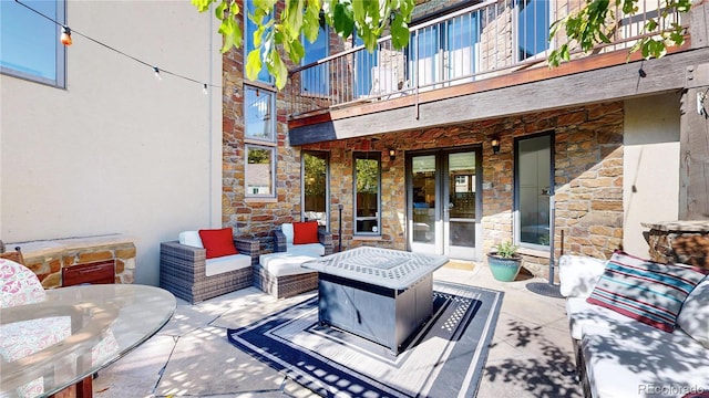 view of patio / terrace featuring french doors, an outdoor hangout area, outdoor dining area, and a balcony