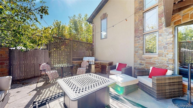 view of patio featuring fence and area for grilling