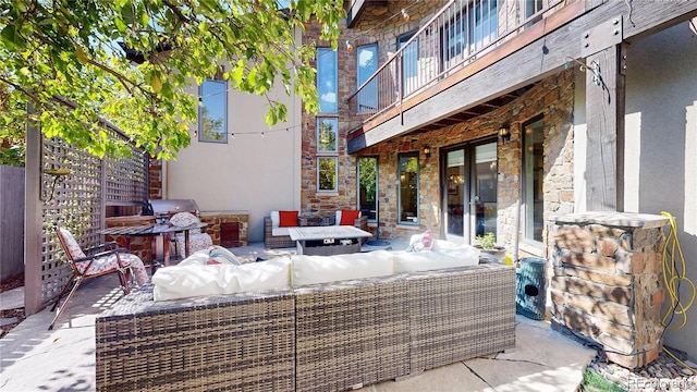 view of patio with french doors, outdoor lounge area, and a balcony