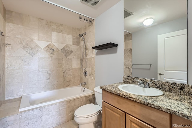 bathroom with visible vents, tiled shower / bath combo, vanity, and toilet