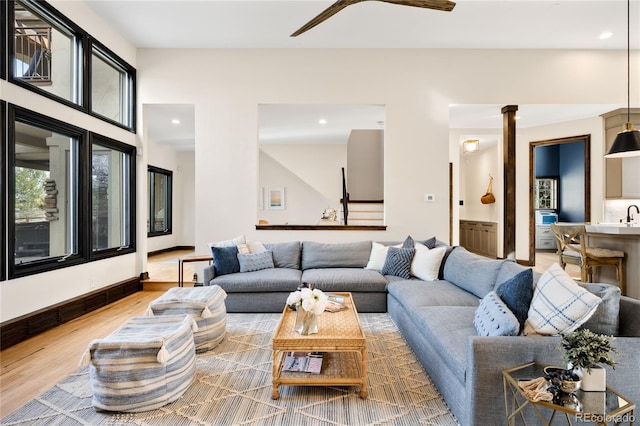 living room with recessed lighting, light wood-style flooring, and a ceiling fan