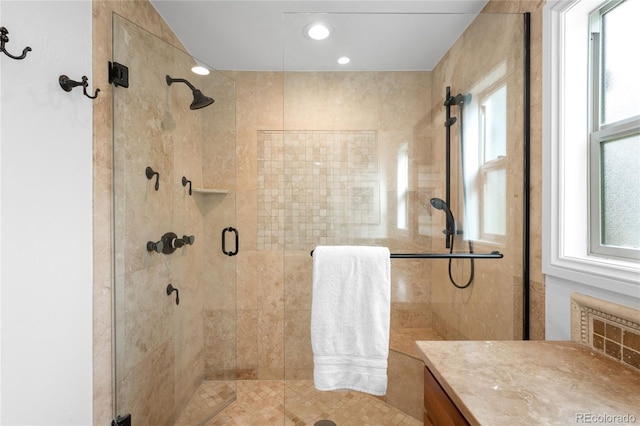 bathroom with a shower stall, vanity, and recessed lighting