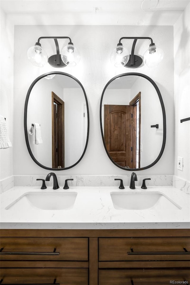 bathroom with a sink and double vanity