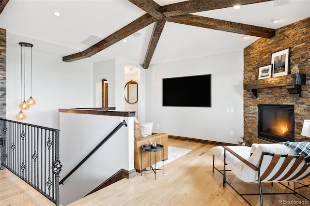 living room featuring baseboards, recessed lighting, visible vents, beamed ceiling, and wood finished floors