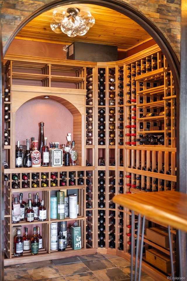 wine area with wooden ceiling and stone finish flooring