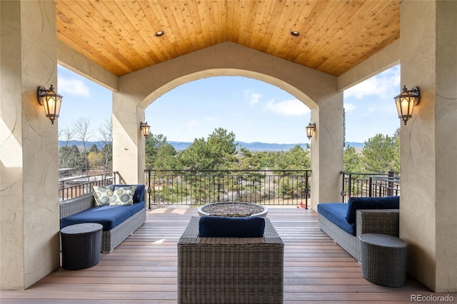wooden terrace with a mountain view and an outdoor hangout area