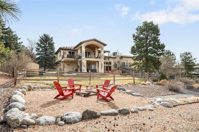 exterior space with fence and an outdoor fire pit