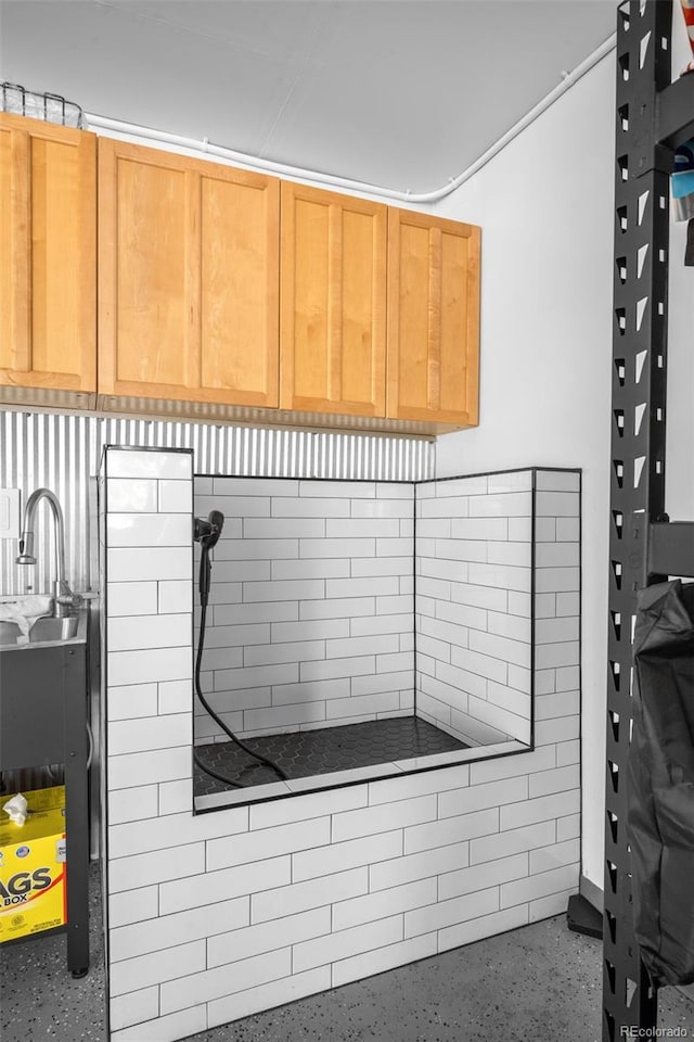 miscellaneous room featuring speckled floor and a sink