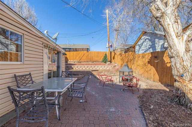 view of patio / terrace featuring outdoor dining area and fence