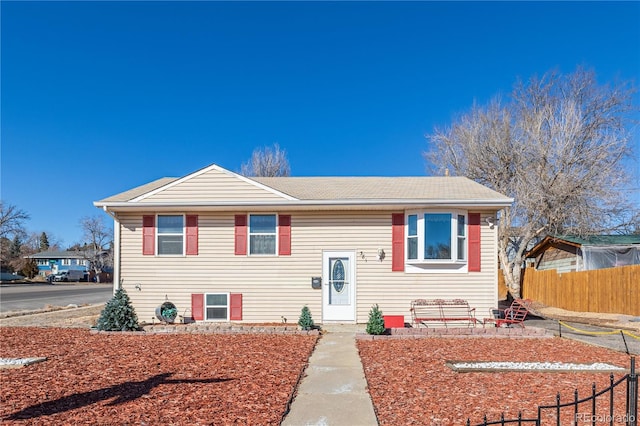 bi-level home featuring fence