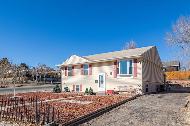 bi-level home featuring fence