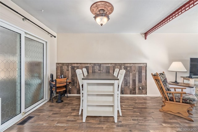 dining space featuring wood finished floors and visible vents