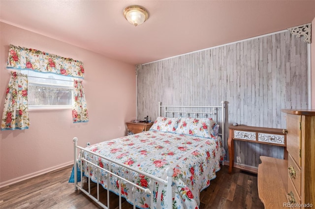 bedroom with baseboards and wood finished floors