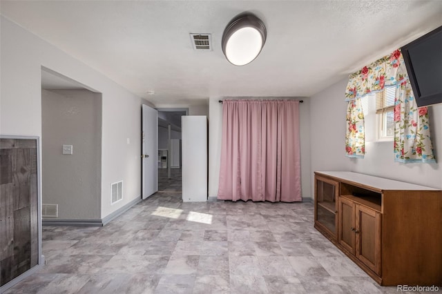 interior space with baseboards and visible vents