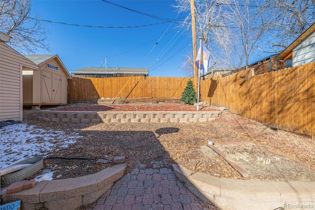 view of yard with a fenced backyard, a storage unit, and an outdoor structure