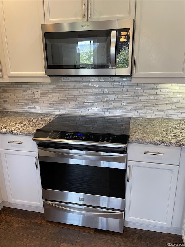 9557 W San Juan Cir Unit 207, Littleton, CO 80128 - kitchen view of stainless steel appliances, white cabinetry, and tasteful backsplash