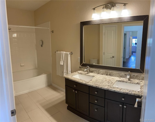 9557 W San Juan Cir Unit 207, Littleton, CO 80128 - full bath with double vanity, tile patterned floors, toilet, baseboards, and tub / shower combination