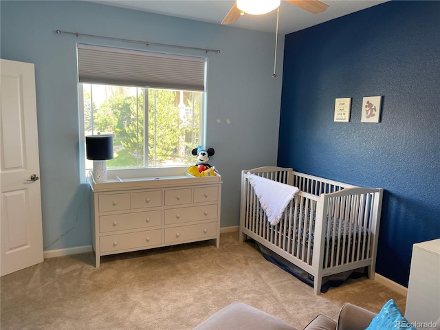 9557 W San Juan Cir Unit 207, Littleton, CO 80128 - bedroom featuring carpet flooring, a crib, baseboards, and ceiling fan