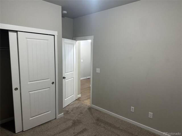 unfurnished bedroom featuring a closet and carpet flooring