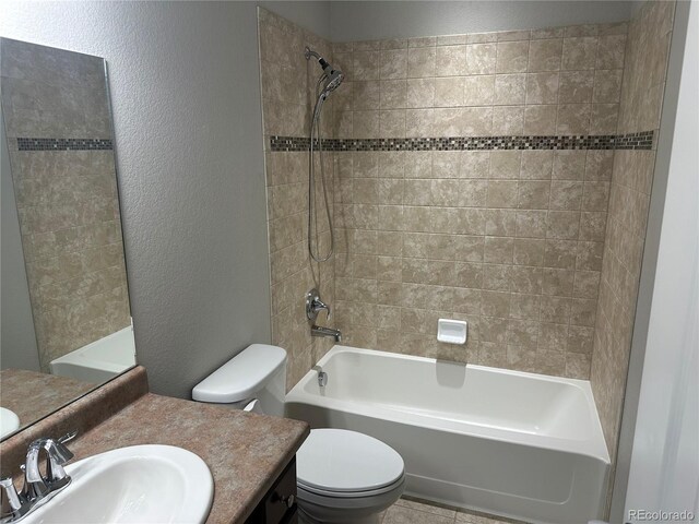 full bathroom with vanity, toilet, and tiled shower / bath