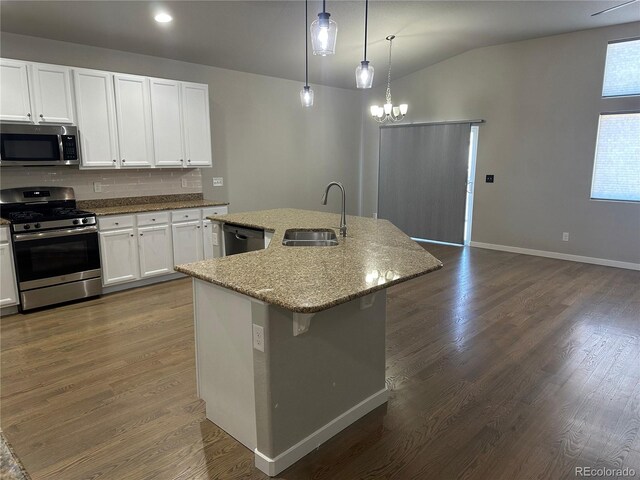 kitchen featuring white cabinets, pendant lighting, stainless steel appliances, a kitchen island with sink, and sink